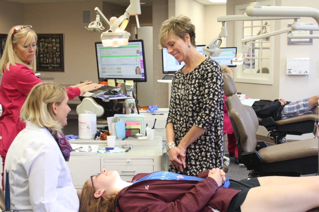 Dr. MaryEvan working with a paitent